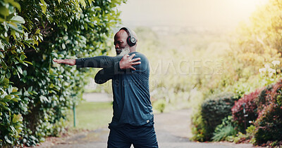 Buy stock photo Stretching, fitness and headphones with black man in nature for runner playlist, streaming and health. Workout podcast, muscle warm up and training with senior person outdoor for wellness and radio