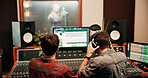 Sound engineer, screen or team in recording studio with mixing console, headphones or music quality. Collaboration, audio and men editing on computer monitor for volume, creative production and back