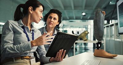 Buy stock photo Women, tablet and discussion for prosthetic leg research, report or future development. Prosthetist, teamwork and design for artificial limbs innovation with 3d foot, mobility aid and feedback chat