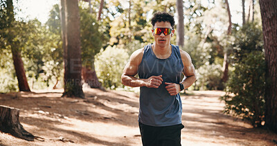 Buy stock photo Running, fitness and man with sunglasses in nature for training, exercise and workout for cardio. Sports, athlete and person on outdoor trail for active hobby, endurance and wellness for health