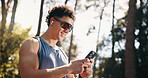 Fitness, happy and man in nature with phone for social media after training, exercise and workout. Sports, athlete and person on smartphone for health app, internet and online chat outdoor