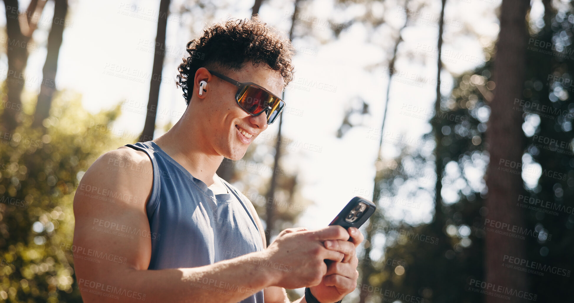 Buy stock photo Fitness, happy and man in nature with phone for social media after training, exercise and workout. Sports, athlete and person on smartphone for health app, internet and online chat outdoor