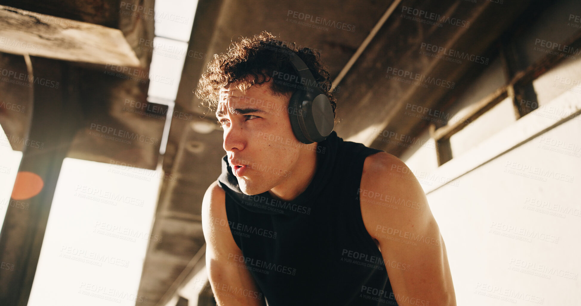 Buy stock photo Athlete, fatigue and man with headphones, bridge or reflection with music subscription for wellness. Outdoor, low angle and person with tech for audio, rest and thinking after exercise and fitness