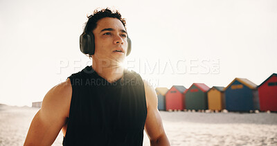 Buy stock photo Athlete, thinking and man with headphones at beach, fitness or memory of wellness with music playlist. Outdoor, runner and person with tech for audio, resting and reflection after exercise and flare
