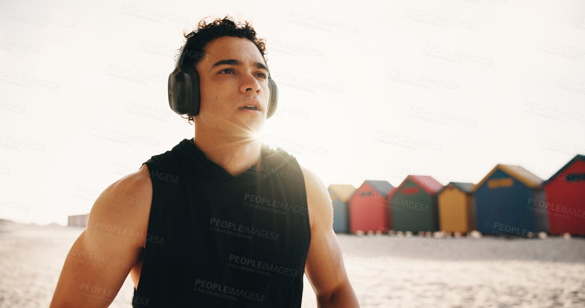 Buy stock photo Athlete, thinking and man with headphones at beach, fitness or memory of wellness with music playlist. Outdoor, runner and person with tech for audio, resting and reflection after exercise and flare