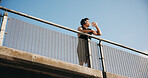 Beach, fitness and man with water on bridge, reflection or hydration after workout routine in nature. Outdoor, space and person with bottle for wellness, low angle and cool down with liquid at ocean