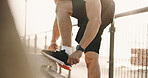 Hands, shoelace and man in city, fitness for wellness and comfort for footwear, sunshine and exercise. Outdoor, athlete and person in street, sneakers and training for health benefits and practice