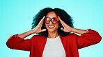 Portrait, woman and heart sunglasses in studio with smile for fashion, accessory and aesthetic. Love expression, romance and person with confidence, eyewear and style for frames on blue background