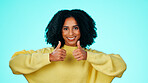 Woman, smile and portrait with thumbs up for vote, opinion and expression of approval in studio. Hand gesture, female person and happy with emoji sign for agreement, like and yes on blue background