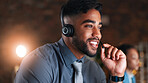 Night, call center and man in workplace, headset for communication and customer service. Evening, person and employee in office, conversation and tech support for advice and contact us for feedback