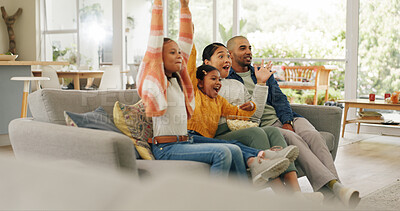 Buy stock photo Parents, children and watching tv in home with celebration, sports game or bonding together on weekend. People, family and girls on couch with popcorn, football broadcast and cheering for match win.