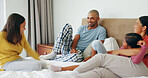 Talking, family and girls in bedroom, relax and bonding together with vacation. Happy mother, father and children in home, comfort and funny story with weekend break, laughing and conversation