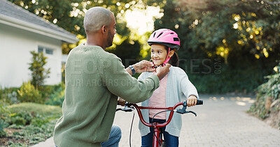 Buy stock photo Helmet, safety and father teaching daughter how to ride bicycle outdoor in front of home. Development, protection and smile of girl child with single parent man in driveway for cycling or learning