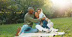 Happy, parents and hug on picnic blanket with child, support or bonding together on weekend break. Mother, father or people smile outdoor on grass with daughter, embrace or love for family connection