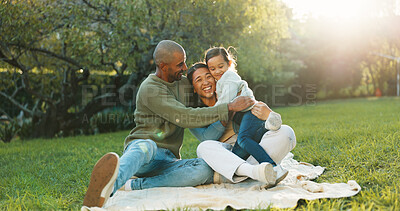 Buy stock photo Happy, parents and hug on picnic blanket with child, support or bonding together on weekend break. Mother, father or people smile outdoor on grass with daughter, embrace or love for family connection