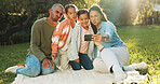 Selfie, parents and kids with funny face on picnic blanket for social media post, vacation and relax. Children, mother and father with family photo on grass for holiday, happy memory or silly at park