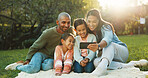 Selfie, parents and children on picnic blanket at park for social media post, vacation and relax. Kids, mother and father with family photo on grass for holiday, happy memory and profile picture