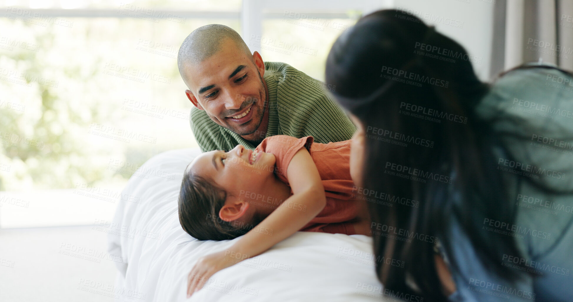 Buy stock photo Happy, parents and play on bed with child, connection and love for bonding together on weekend break. Mother, father and people in house with daughter with smile, relax and care for family wellness.