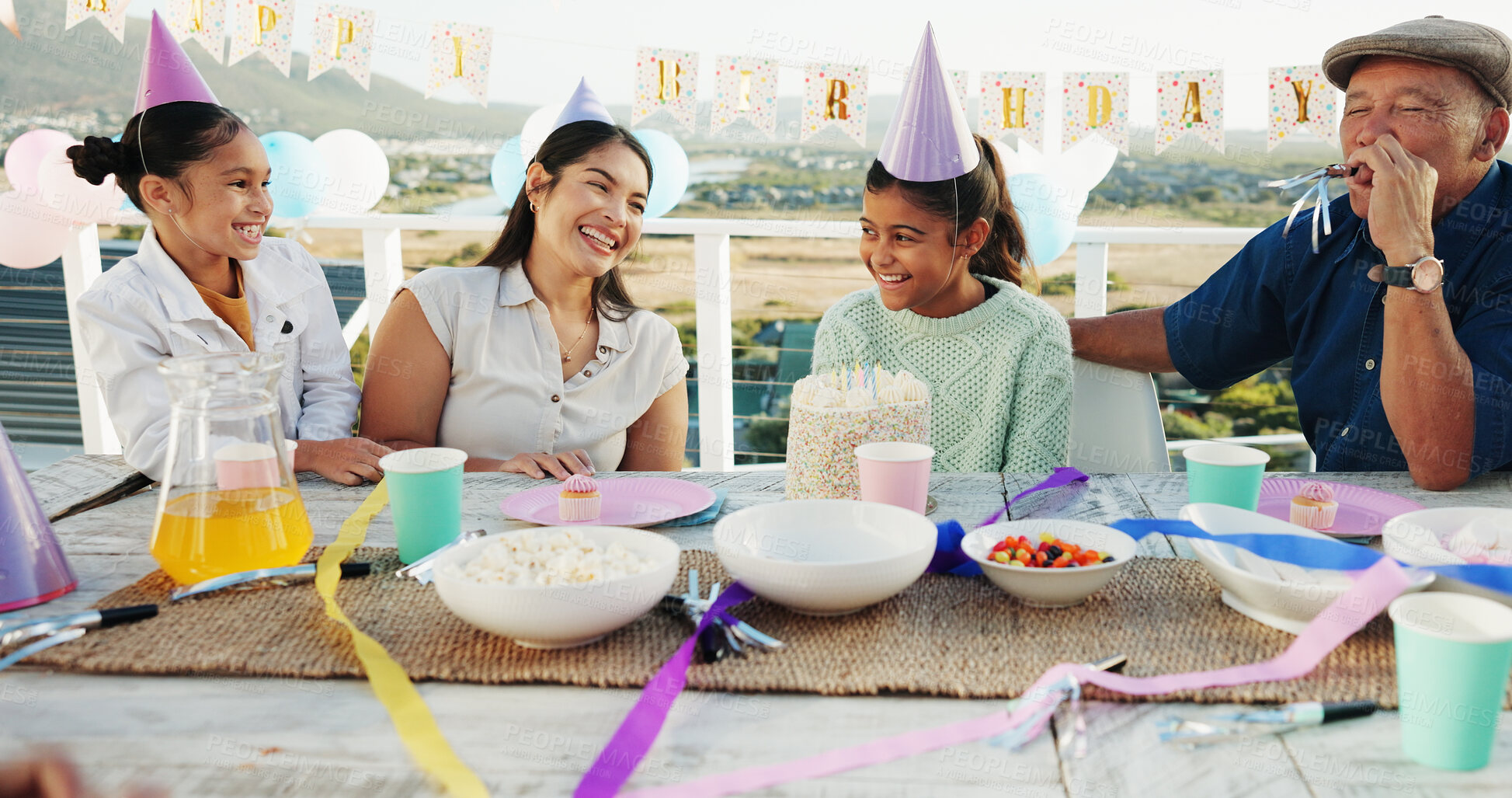 Buy stock photo Happy, family and children at birthday party with cake, snacks and generations bonding in backyard. People, smile and girls outdoor on balcony with mother, grandfather or sweets for celebration event
