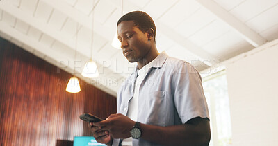 Buy stock photo Message, review or black man in office with phone, agenda change or project discussion in online chat. Reading, digital or employee in agency with tech, meeting schedule and feedback on report update