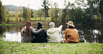 Buy stock photo Friends, relax and talk at park by lake, point or embrace on hiking trip, break and nature tourism. People, group and travel for view on grass, dam and outdoor for sightseeing with rest on holiday