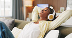 Black woman, headphones and relax with rest in home, eyes closed and streaming service on sofa. African person, chill and listen to music with audio tech, sound or subscription on couch at house
