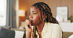 Nervous, thinking and girl with stress on sofa for university crisis, student debt or scholarship risk. Black person, thoughtful and worry in home for college loan, biting nails and academic pressure
