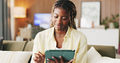 Buy stock photo Black woman, tablet and typing on sofa in home with smile, scroll and notification in living room. African person, tech and happy with application, online dating or web chat on social media at house