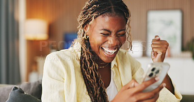 Buy stock photo Fist pump, winner and phone with black woman on sofa in home for online casino prize, success and bonus. Connection, jackpot profit and app with person in living room of house for achievement