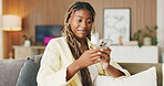 Happy, reading and phone with black woman on sofa in home for communication, social media and smile. Contact, online chat and connection with person and mobile in living room of apartment for app