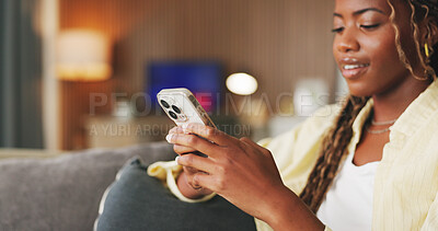 Buy stock photo Smile, typing and phone with black woman on sofa in home for communication, social media and relax. Contact, online chat and connection with person and mobile in living room of apartment for app