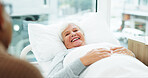 Smile, senior woman and visit in hospital bed for emotional support, bonding or medical recovery. Happy, elderly couple or checkup on patient, partner compassion and healing from healthcare operation