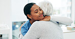 Support, hug and nurse with senior woman in hospital for conversation, comfort or empathy at checkup. Smile, trust and medical caregiver with elderly patient embracing at healthcare consultation.