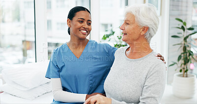 Buy stock photo Happy, hug and nurse with senior woman in hospital for conversation, comfort or support at checkup. Smile, trust and medical caregiver with elderly female patient embracing at healthcare consultation