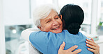 Empathy, hug and nurse with senior woman in hospital for conversation, comfort or support at checkup. Smile, trust and medical caregiver with elderly patient embracing at healthcare consultation.