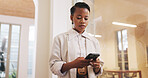 Phone, typing and black woman in office with social media, text message or review for business email. Person, scroll or check notification in workplace with tech, mobile app or browse for online chat