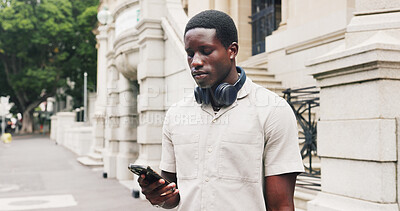 Buy stock photo Phone, outdoor and black man in city with contact, email or communication for university application. Cellphone, reading and African male student on mobile app for online college results in town.