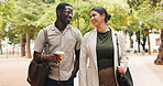 Business, people and commute in park with smile, public relations job and coffee for morning chat. Happy, coworkers and walk outdoor with journey, conversation and beverage for travel to PR agency.