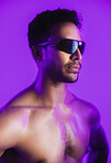 Man, sunglasses and topless in studio with bodybuilding, muscle or aesthetic on purple background. Person, shades and strong with neon glow, shirtless or transformation for wellness with healthy body