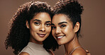 Portrait, women and smile in studio with skincare, bonding together and makeup for beauty aesthetic. Happy, friends and confident with glowing skin, cosmetics and dermatology on brown background.
