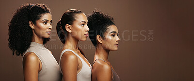 Buy stock photo Women, skincare and makeup in studio for beauty, empowerment or inclusion on a brown background. Female people, model or glow up in row on banner with shine for cosmetics or cosmetology on space