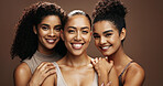 Confident, portrait and women with makeup for glow, group and self care with cosmetics for wellness. Studio background, sisters and people with smile for skincare, embrace and dermatology in Brazil