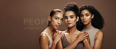 Buy stock photo Serious, women and friends with makeup in studio for beauty, natural glow and inclusion. Portrait, mockup space and people with banner, facial cosmetics and support for aesthetic on brown background