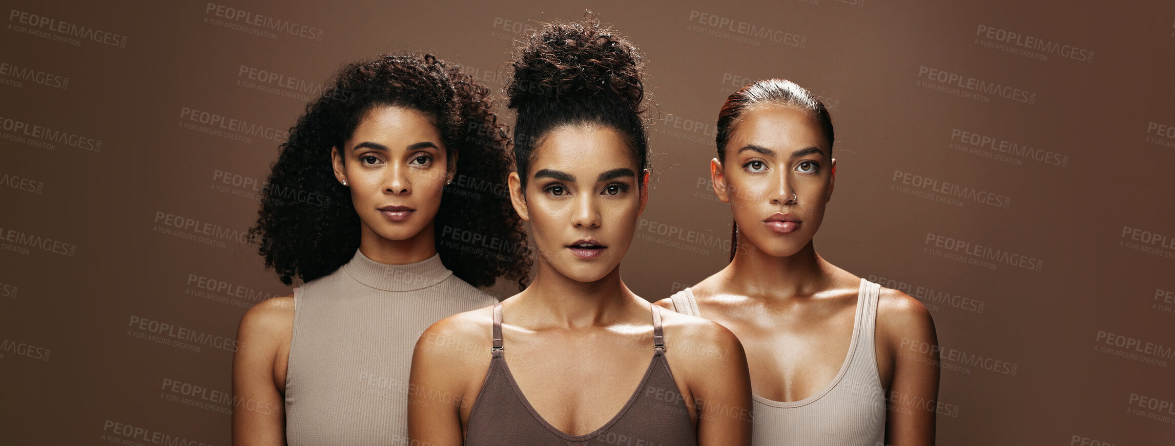 Buy stock photo Women, portrait and skincare with makeup in studio for beauty or empowerment on a brown background. Female people, model or glow up in row on banner with shine for cosmetics or cosmetology together