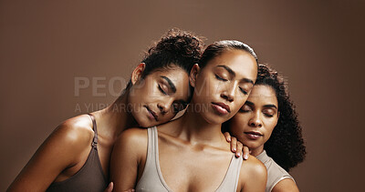 Buy stock photo Group, women and friends with makeup in studio for beauty, natural glow and inclusion. Space, people or eyes closed with support, facial cosmetics and skincare shine for aesthetic on brown background