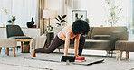 Woman, yoga and block on floor with tablet, online class and stretching for holistic health in home. Fitness, person and balance exercise in living room with lunge, pilates or tech for video tutorial