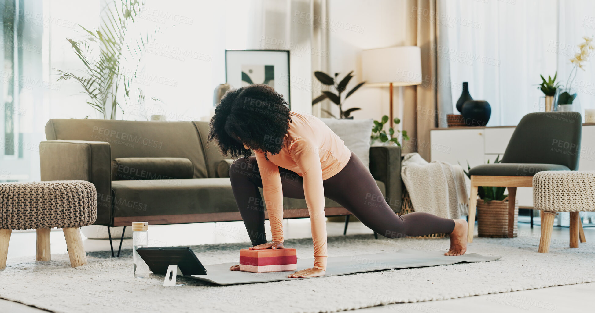 Buy stock photo Woman, yoga and block in living room with tablet, online class and stretching for holistic health. Fitness, person and balance exercise in home with lunge, pilates or digital tech for video tutorial.