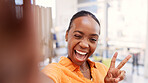 Happy woman, portrait and wink for selfie in home, online and peace sign for picture on social media. Influencer, photography and black person with smile for image, laugh and goofy memory on website