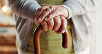 Senior, person and hands with cane in home for mobility, old age assistance or walking aid. Closeup, elderly or support with wooden stick for stability, safety or help in retirement or nursing house