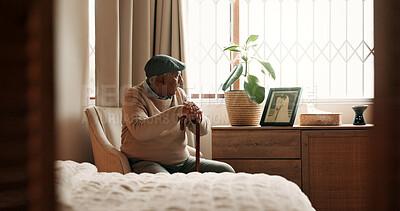 Buy stock photo Thinking, grief or old man in house with walking stick, mourning or memory of marriage in bedroom. Mental health, reflection and senior person with disability, nostalgia or partner loss in retirement